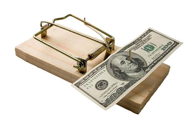 a picture of a mousetrap where the United States 100 dollar bill is used as bait